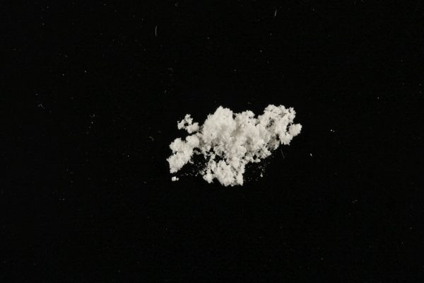 5-HO-DMT (Bufotenine) powder on a surface, displaying its fine crystalline texture.