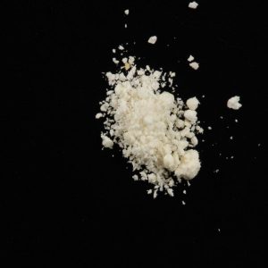 A fine white powder representing 5-Bromo-DMT, a potent psychedelic compound related to DMT, often used for research and psychoactive exploration.