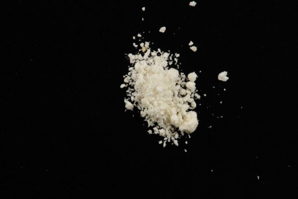 A fine white powder representing 5-Bromo-DMT, a potent psychedelic compound related to DMT, often used for research and psychoactive exploration.